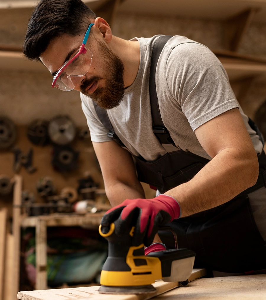 A man sanding timber showing the care and attention to detail shown by Moorlands Garden Furniture