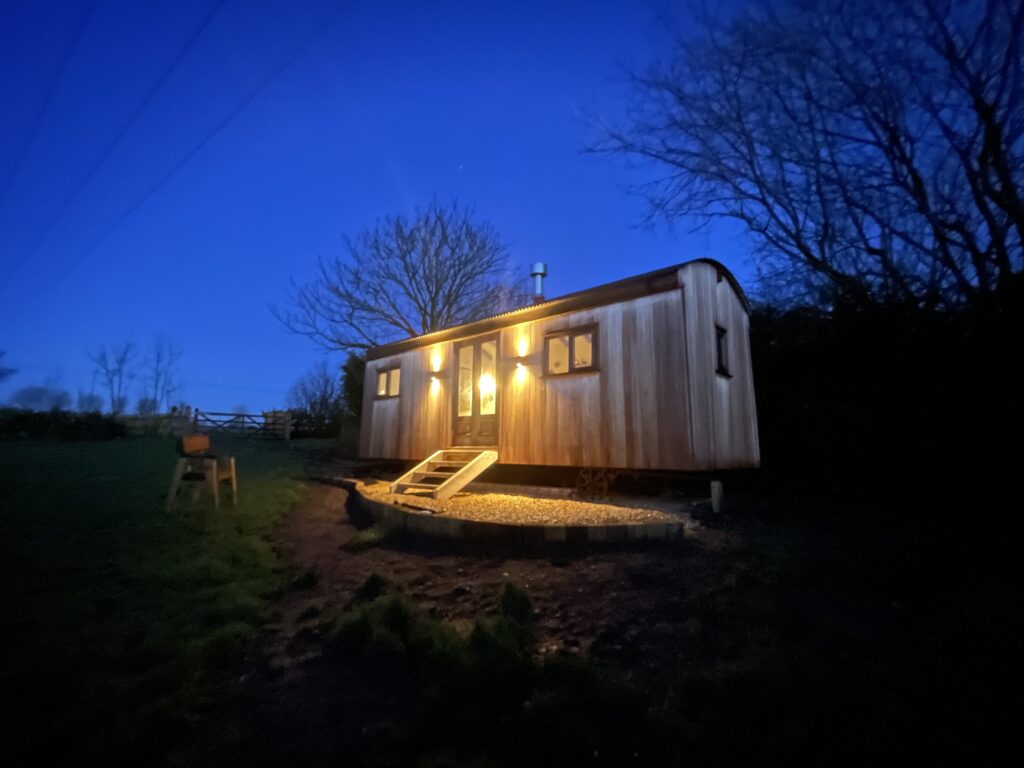 A Herdwick Shepherd Hut Clad In Red Grandis at Night