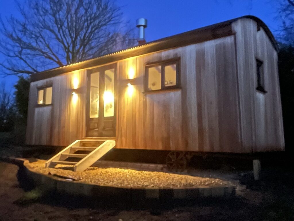 A Herdwick Shepherd Hut Clad In Red Grandis at Night