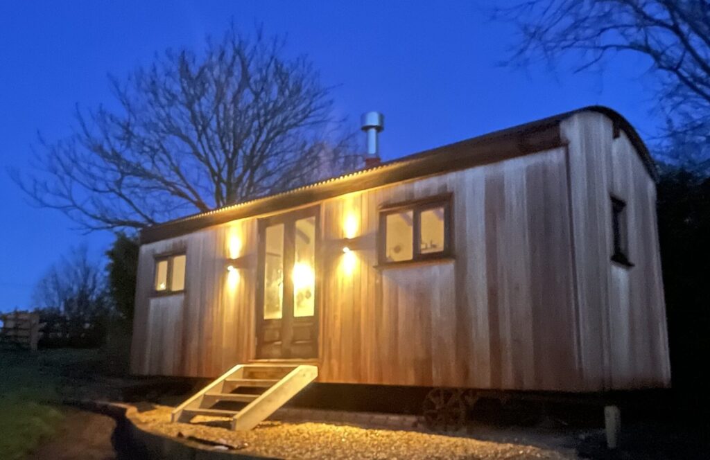A Herdwick Shepherd Hut Clad In Red Grandis at Night